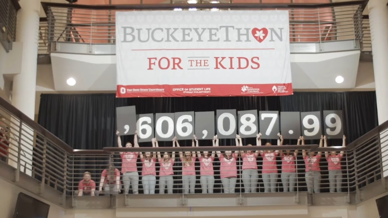 Ohio State University students celebrate BuckeyeThon fundraiser results inside the student union