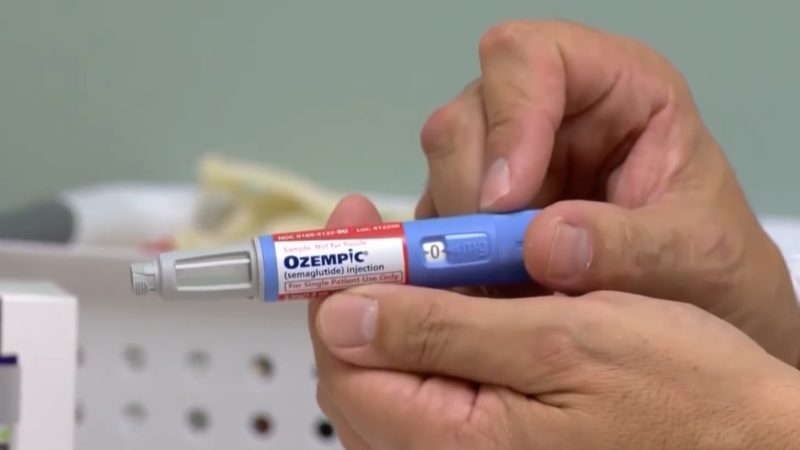 Person holding an Ozempic injection pen labeled semaglutide
