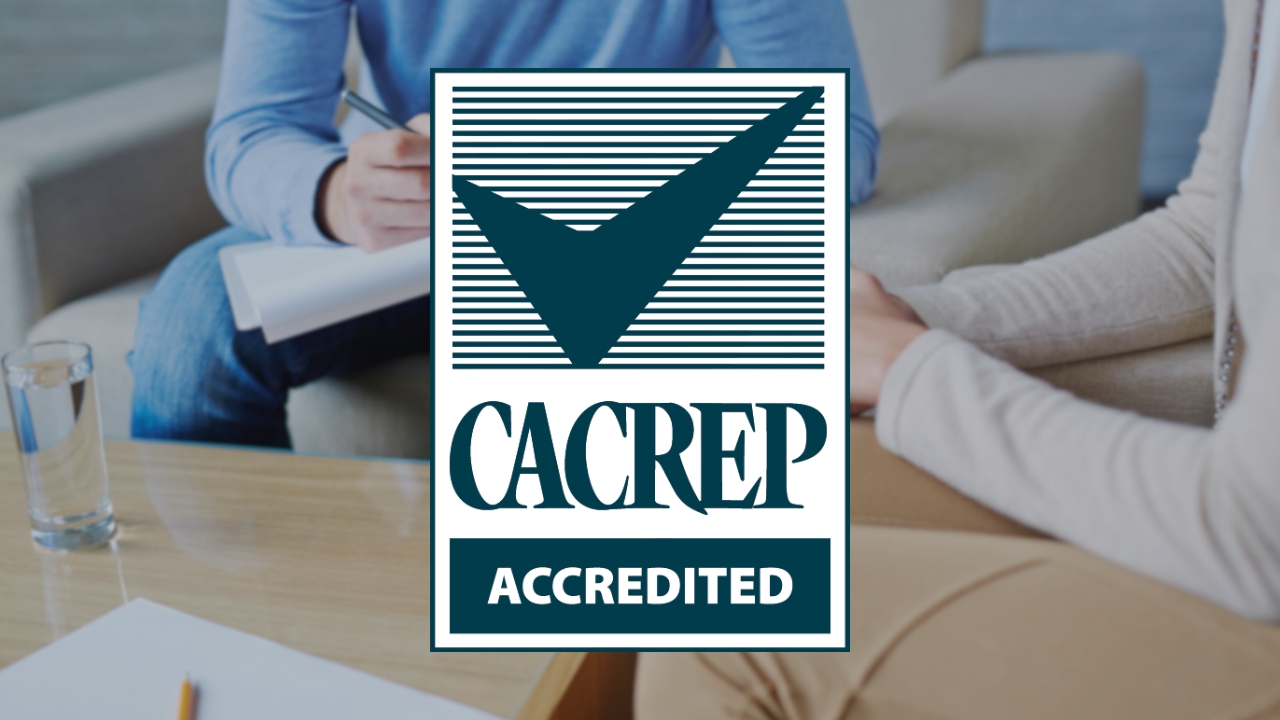CACREP accredited counseling program logo over a counseling session between a therapist and a client