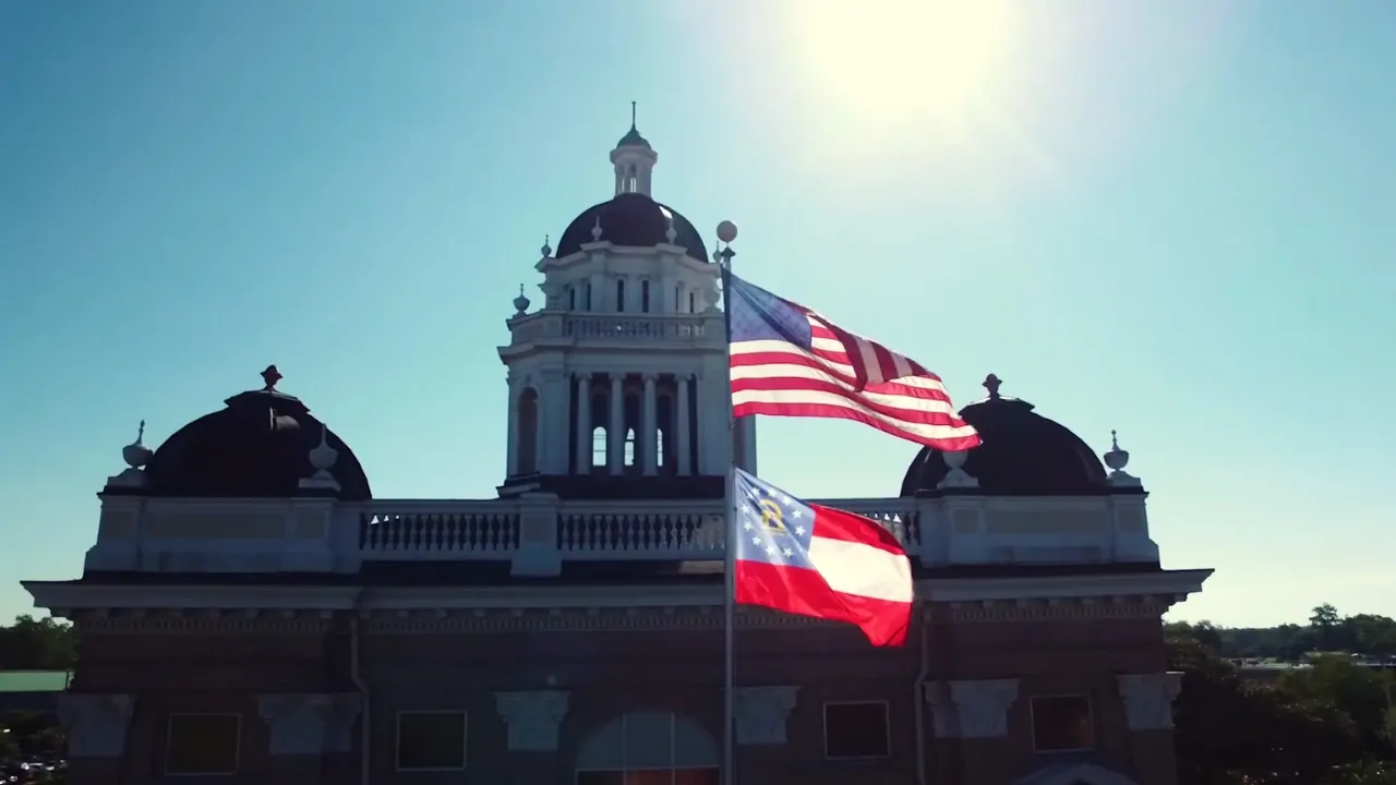 Valdosta State University campus building with the U.S. and Georgia flags flying in front