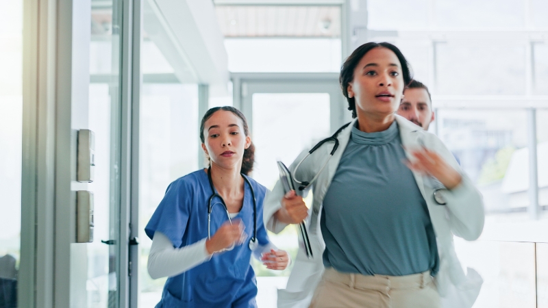 Doctors and nurses running through a hospital corridor during an emergency response
