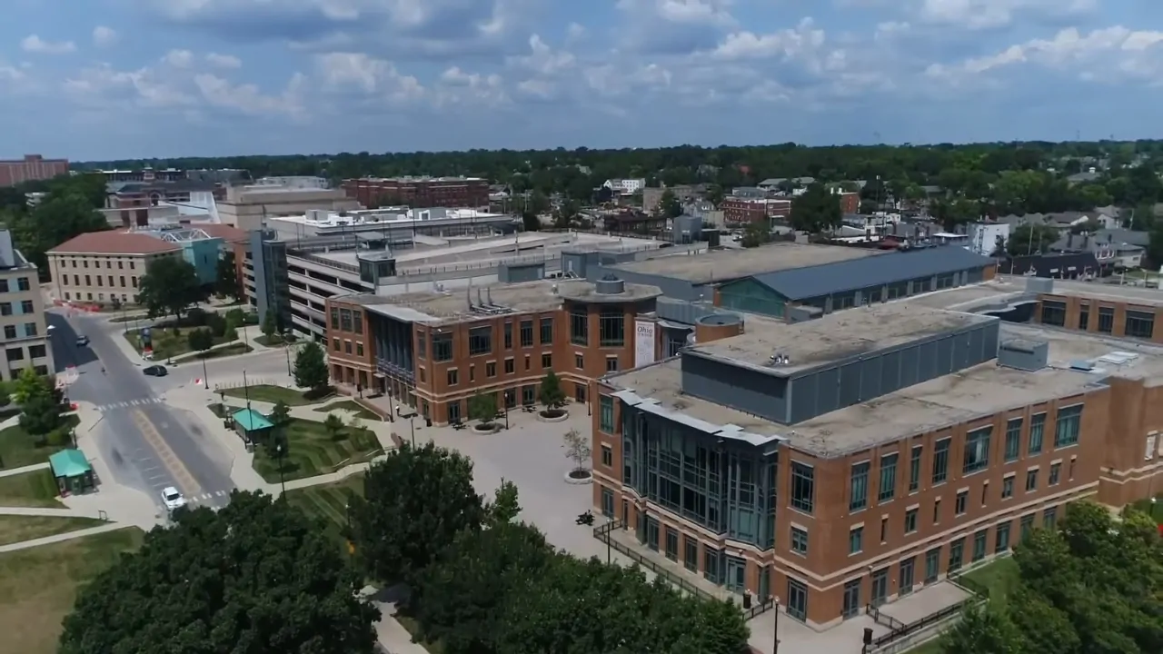 Aerial view of the Ohio State University campus with large academic buildings and surrounding city streets