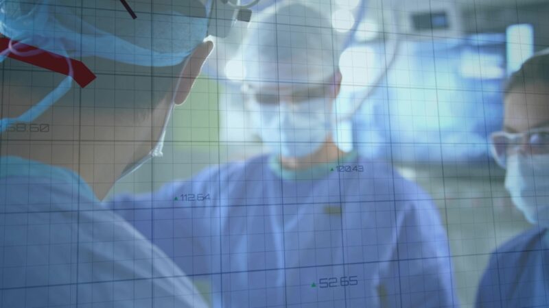 Doctors review data in an operating room to assess the impact of community surgical centers