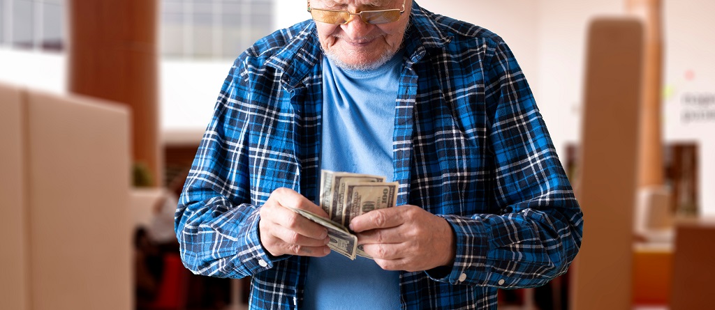 Senior elder man counting money