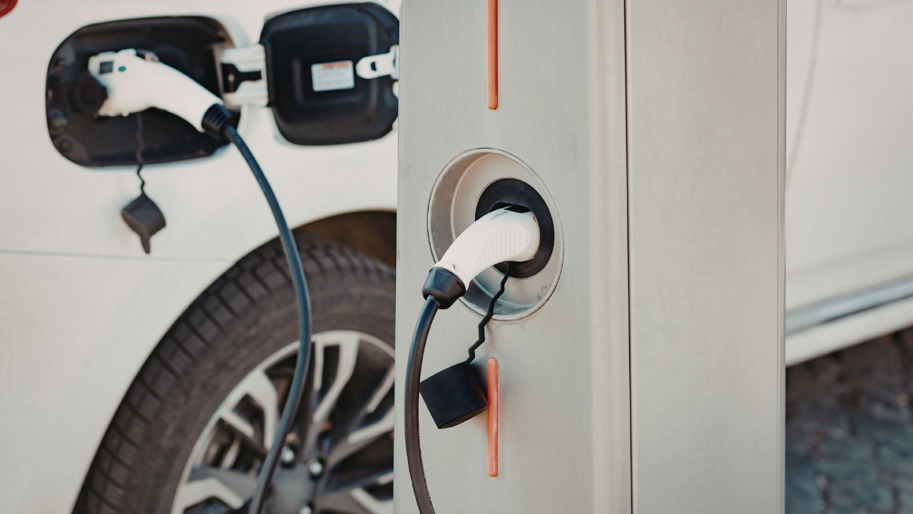 An electric car plugged into a public charger as the Electric Vehicle Fee Bill proposes a yearly EV owner charge