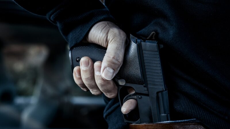 Person holding a handgun during a concealed carry draw
