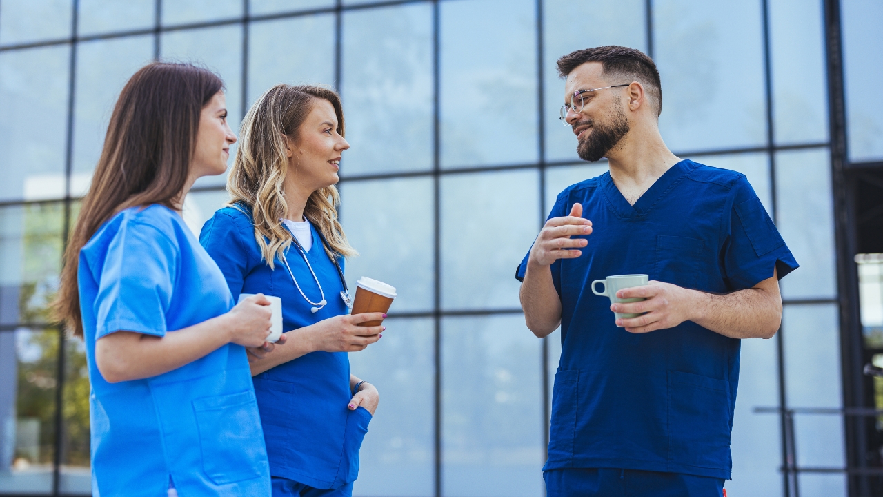 Hospital staff talk outside during a brief break between shifts