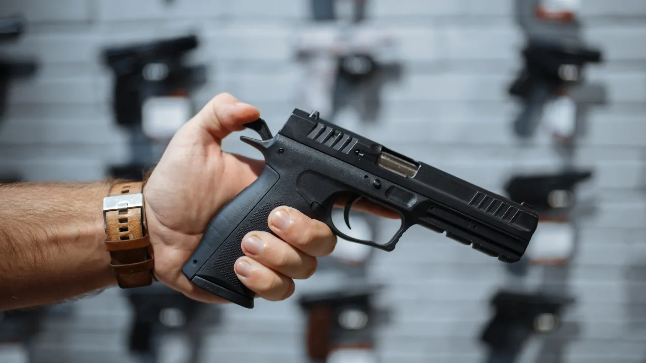 Person holding a handgun inside a gun store in the US