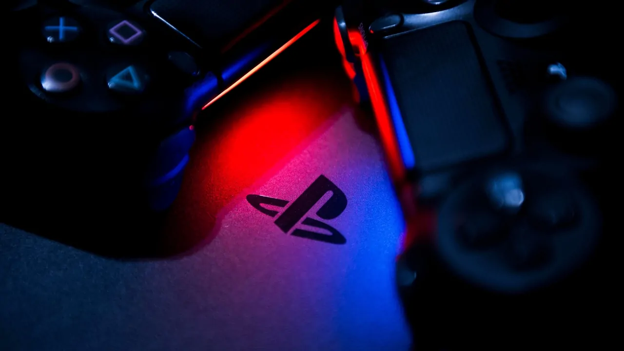 PlayStation controllers next to a PlayStation logo during the Sony digital games settlement news