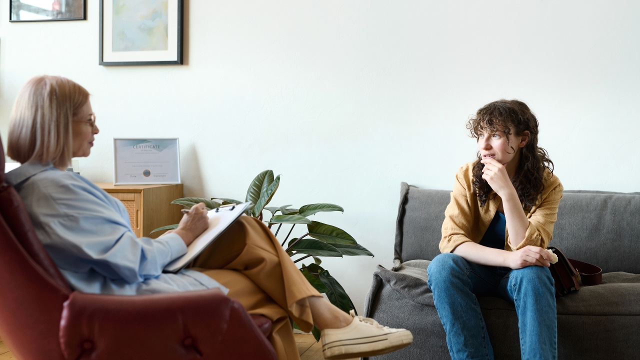 Adult ADHD patient speaking with a therapist during a counseling session