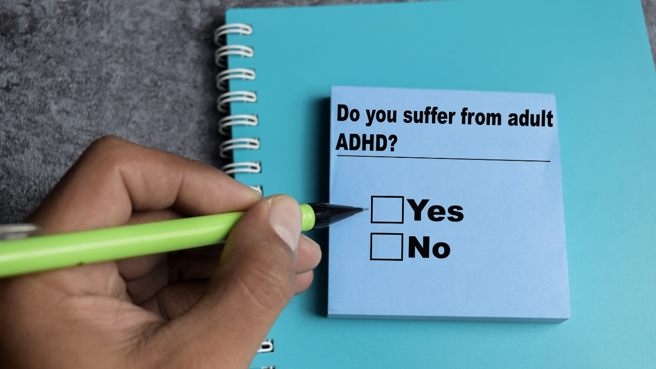 Hand marks a checklist about adult ADHD symptoms