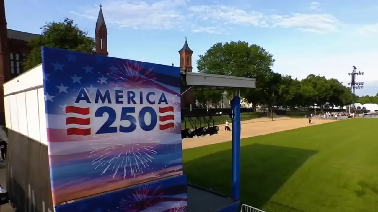 An America 250 sign stands beside a stage on the National Mall