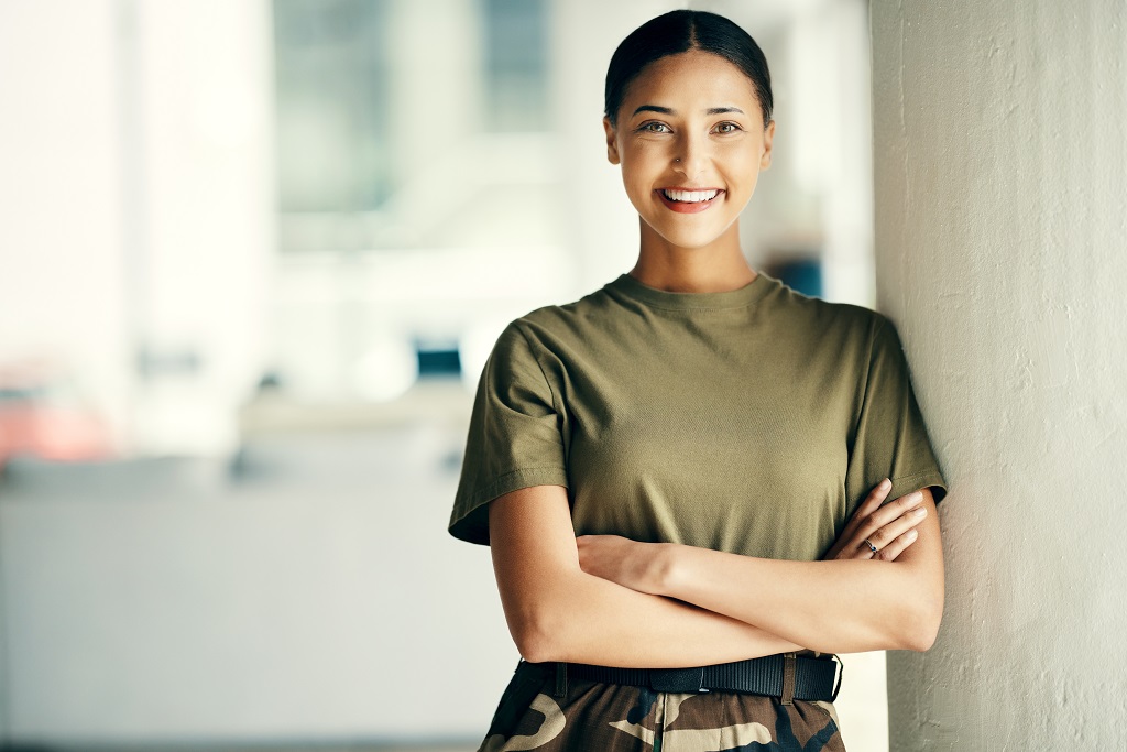 Female military service member standing confidently in uniform