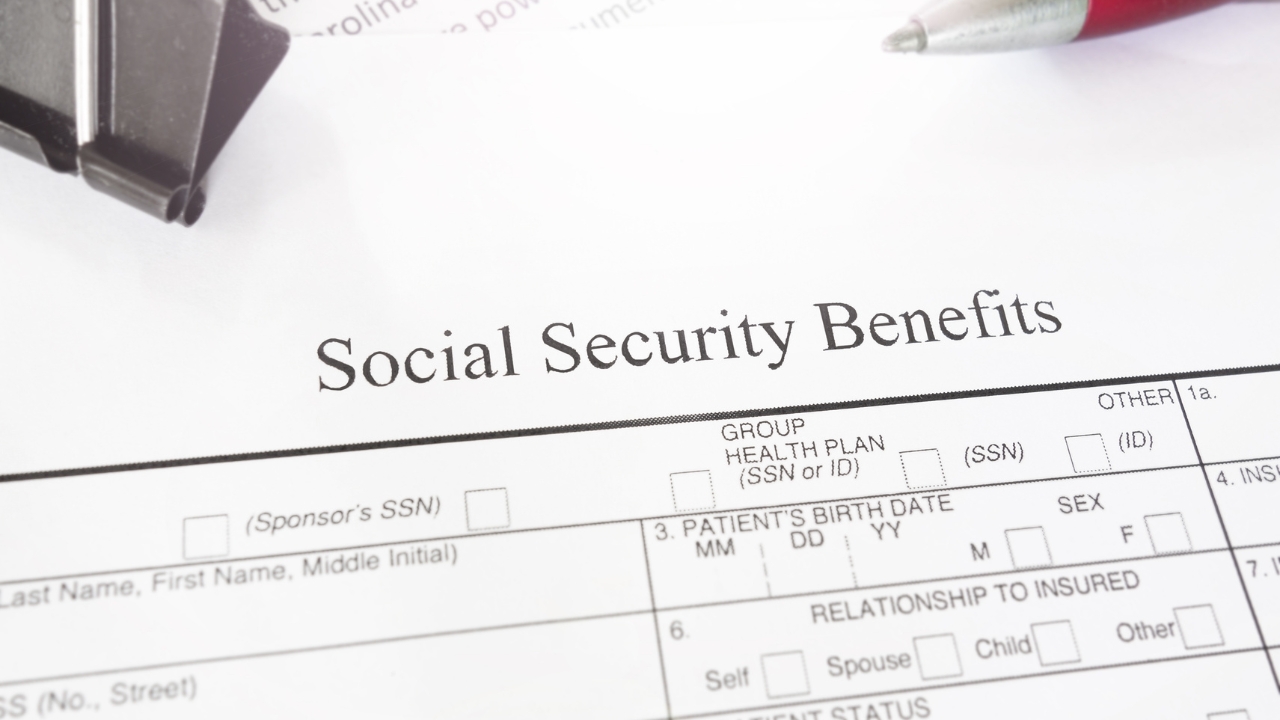 Social Security benefits form placed on a desk with a red pen nearby