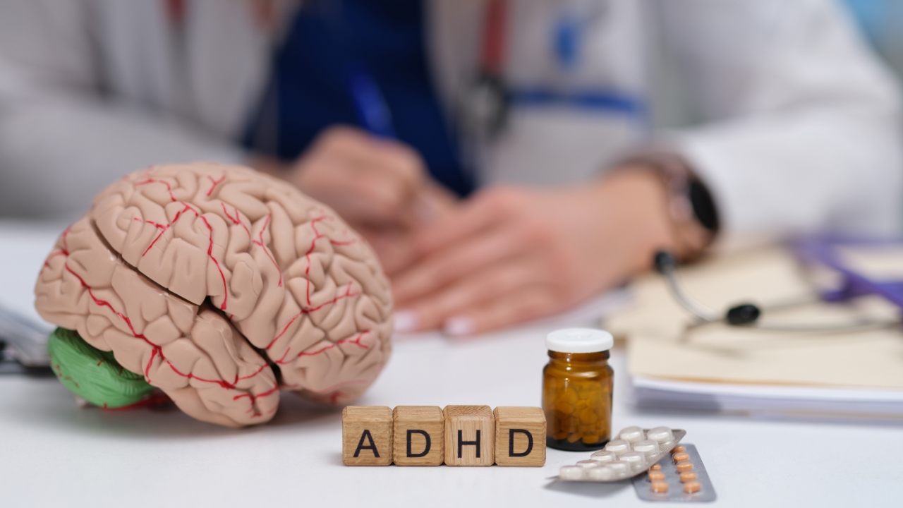 Doctor desk with an ADHD label, brain model, and medication