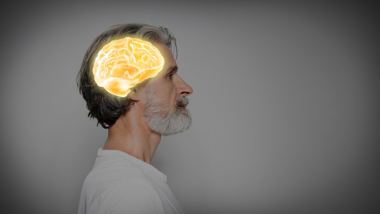 Man with a glowing brain graphic representing brain aging research