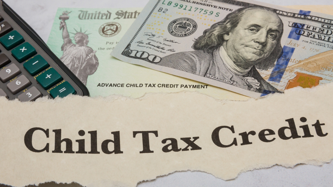 A Child Tax Credit notice is shown with cash, a calculator, and a payment check