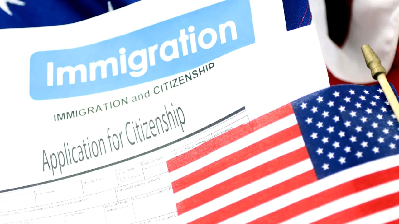 A U.S. citizenship application lies beside an American flag