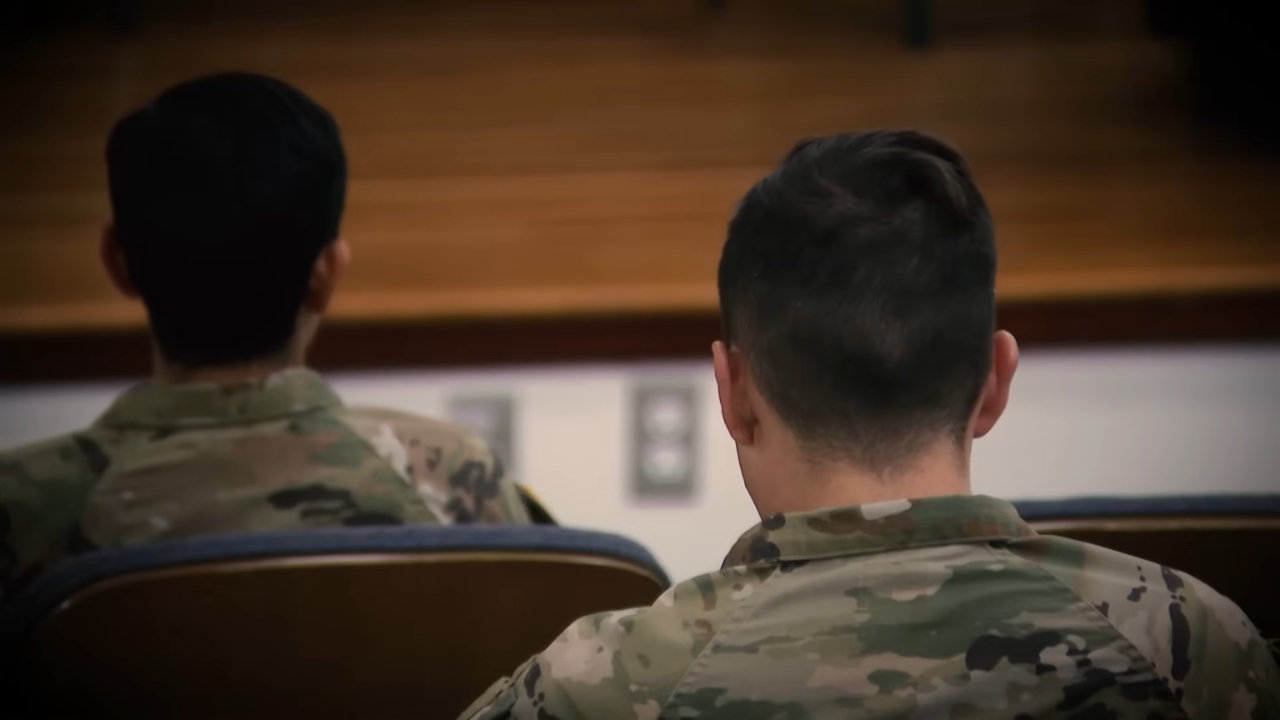 Two U.S. service members sit in a military classroom
