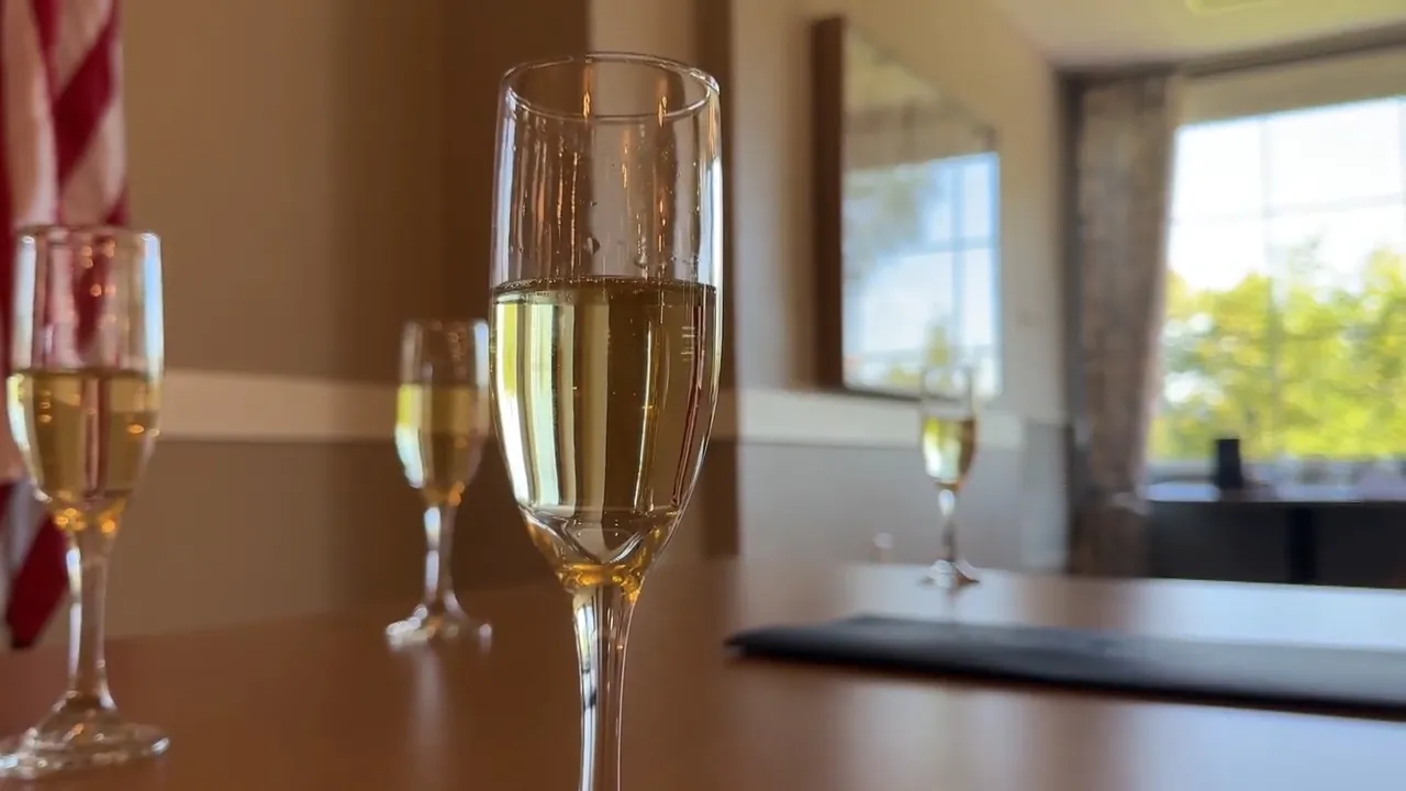 Champagne glasses sit on a table at a senior community event