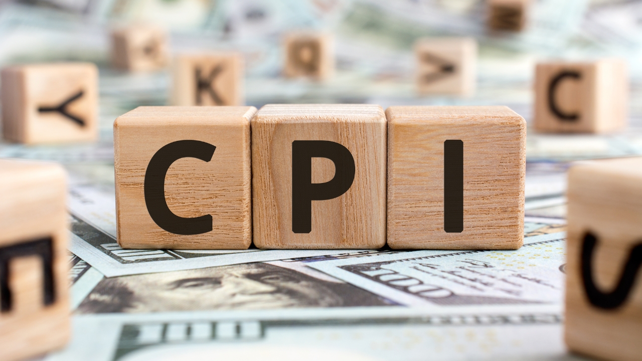 Wooden CPI blocks sit on U.S. dollar bills