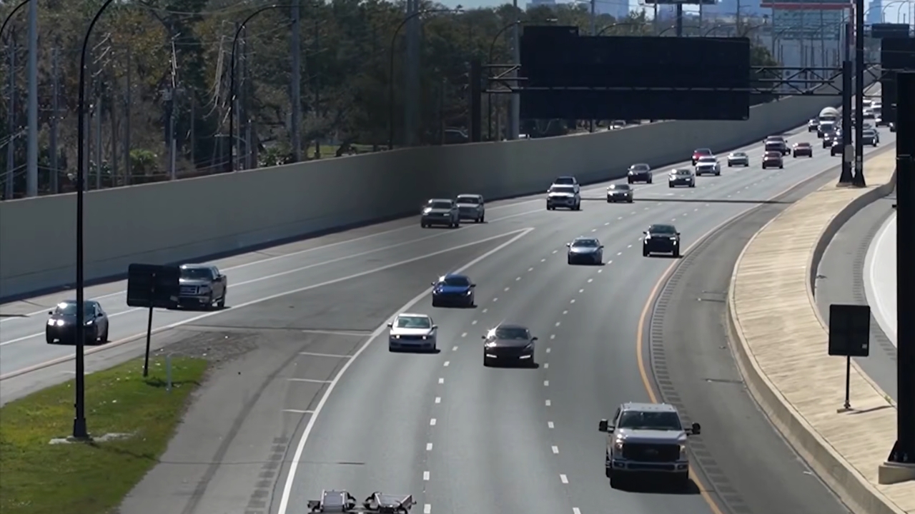 Cars travel along a wide Florida highway in daylight