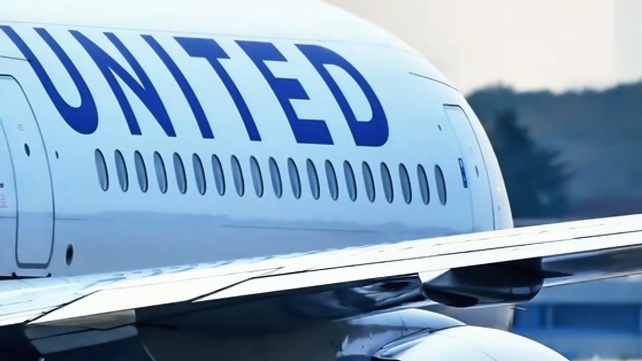 United Airlines aircraft on the runway with its wing and fuselage in view