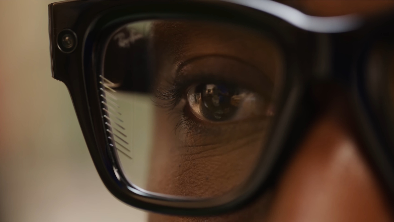 Close-up of a person’s eye behind black smart glasses