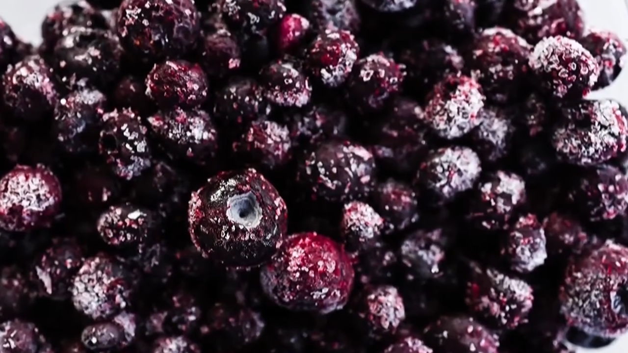 Frozen blueberries covered with visible ice crystals