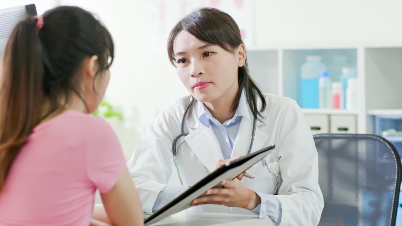 Chinese doctor speaks with a patient during a medical consultation