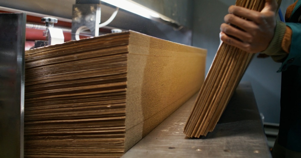 Plywood sheets being processed in a factory