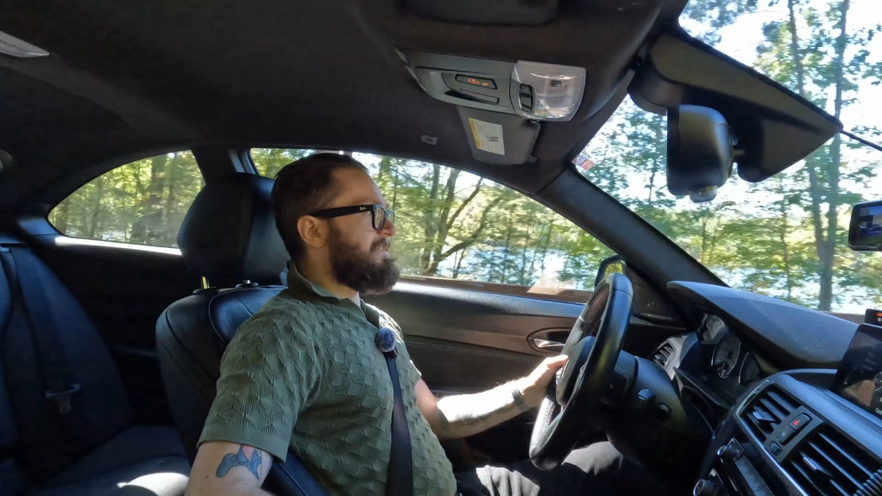 Man wears smart glasses as he drives a car