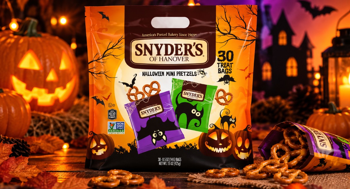 Snyder’s of Hanover Halloween Mini Pretzels multipack with individually wrapped pretzel bags, surrounded by glowing pumpkins and Halloween decorations.